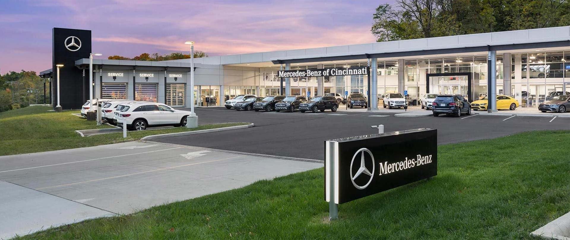 Photograph of the front of the Mercedes-Benz of Cincinnati dealership and lot.