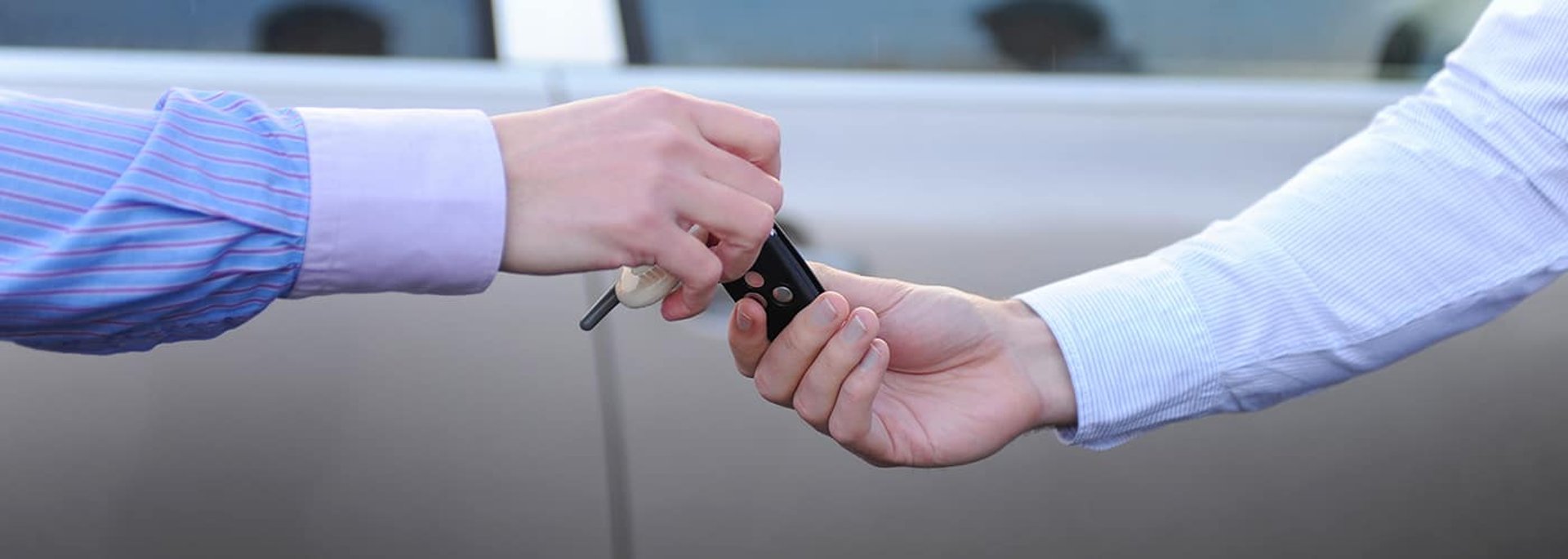man hands the keys to the car